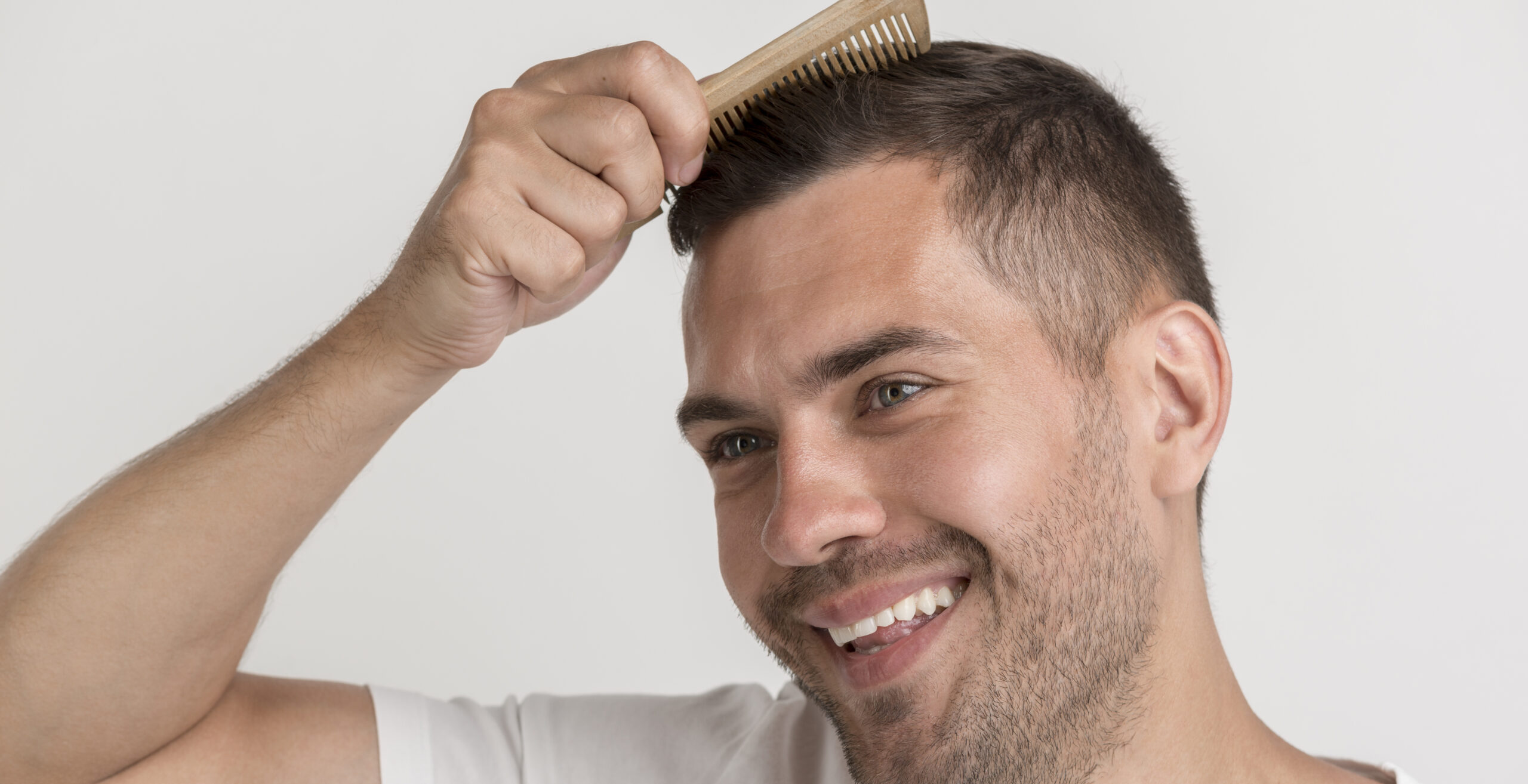 smiling man combing hair