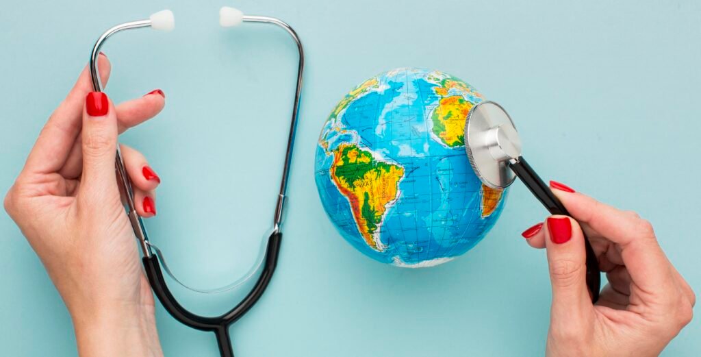 top view of hands holding stethoscope with a globe